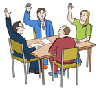 An einem Tisch sitzen vier Personen, die gerade per Handzeichen abstimmen